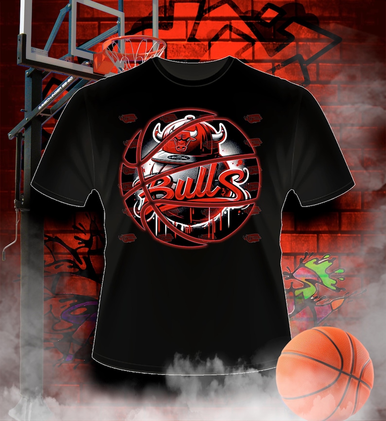 May include: Black t-shirt featuring a red and white basketball graphic. The basketball has a red bull's head logo and the word "Bulls" written in red.