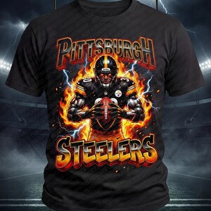May include: Black t-shirt with a graphic of a Pittsburgh Steelers player engulfed in flames, holding a football. The team's name, 'Steelers', is written in fiery letters above and below the player.