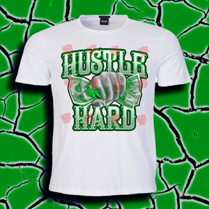 May include: White t-shirt with a green and white graphic design that says "Hustle Hard" with a hand holding money.