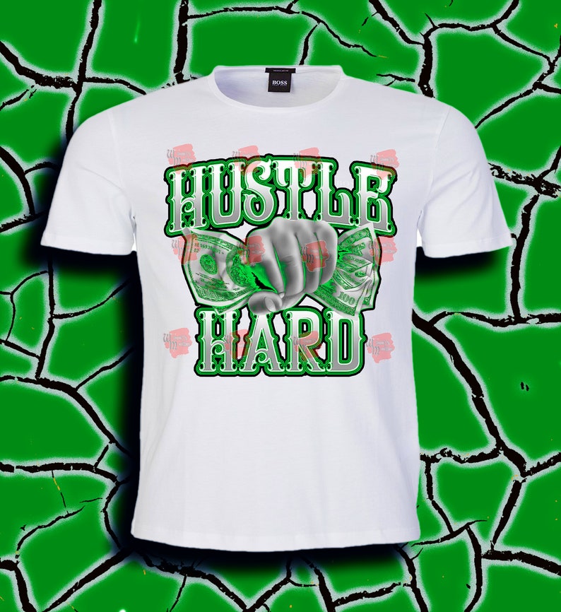 May include: White t-shirt with a green and white graphic design that says "Hustle Hard" with a hand holding money.