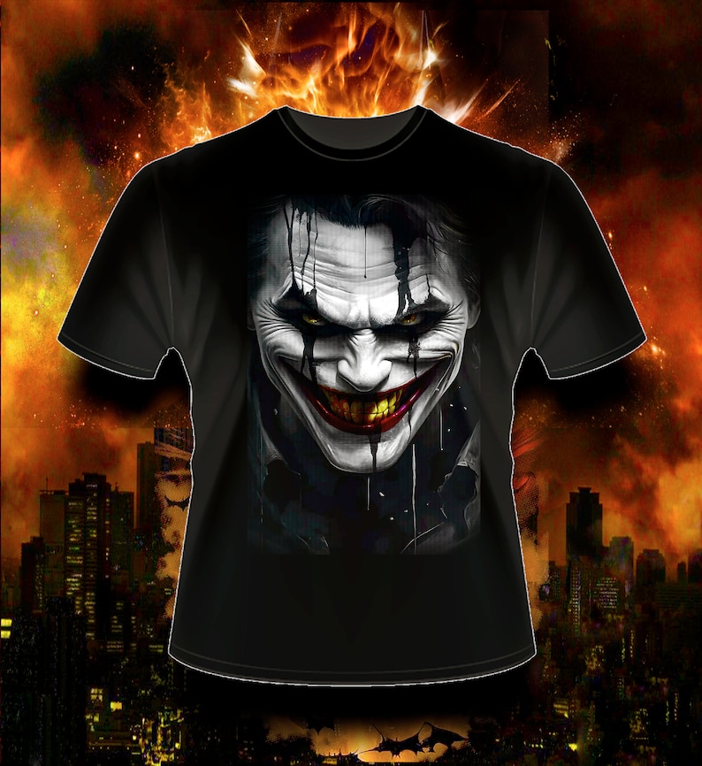 May include: Black t-shirt with a graphic print of the Joker's face. The Joker is smiling with a wide, toothy grin. His face is painted white with black and red accents.