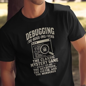 May include: A black short-sleeved t-shirt featuring white text that reads DEBUGGING /DE-BUGG-ING/-VERB, an icon of a computer window with a magnifying glass over a bug, and the text THE CLASSIC MYSTERY GAME WHERE YOU ARE THE DETECTIVE, THE VICTIM, AND THE MURDERER.