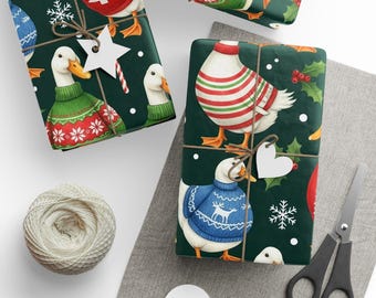 May include: Gift-wrapped presents with a festive duck pattern. The wrapping paper features ducks in sweaters and holiday accents. Presents are tied with twine and adorned with star and heart-shaped gift tags. A spool of twine and scissors are also visible.