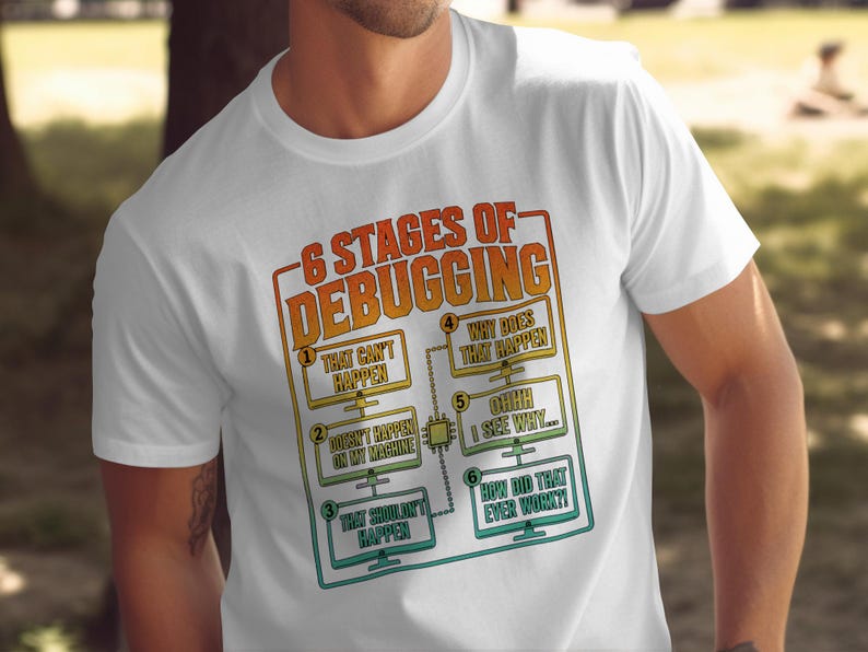 White t-shirt with "6 Stages of Debugging" humor design.