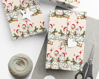 May include: Christmas-themed gift wrap featuring a repeating pattern of geese wearing Santa hats and string lights. The gifts are tied with twine and adorned with star-shaped and heart-shaped tags. A spool of twine and scissors are also visible.