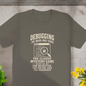 Shirt with text "Debugging: The Classic Mystery Game" and a magnifying glass over a bug.