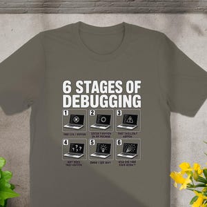 T-shirt with "6 Stages of Debugging" graphic depicting laptops with error messages.