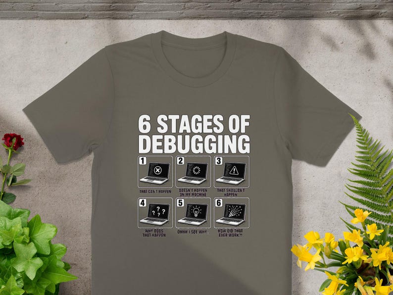 T-shirt with "6 Stages of Debugging" graphic depicting laptops with error messages.