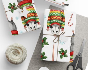 May include: Gift-wrapped presents with opossum illustrations wearing Christmas sweaters. The wrapping paper features opossums, snowflakes, and holly. Presents are tied with twine and heart-shaped tags. A spool of twine, scissors, and blank tags are also visible.