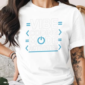 White t-shirt with "Vibe Coding Mode Activated" in blue text.