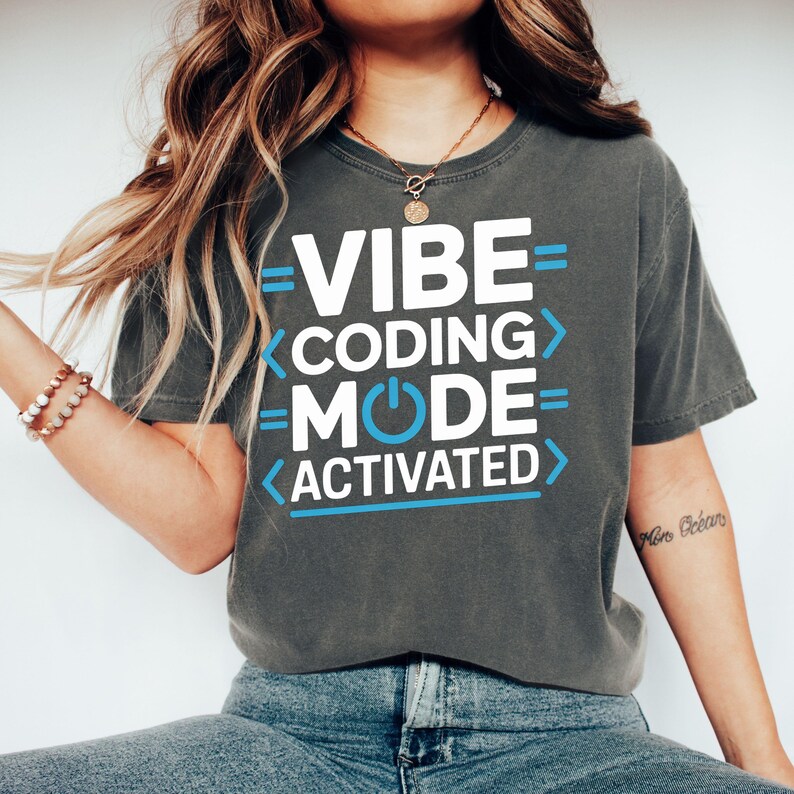 Dark t-shirt with blue text "VIBE < CODING MODE > ACTIVATED"