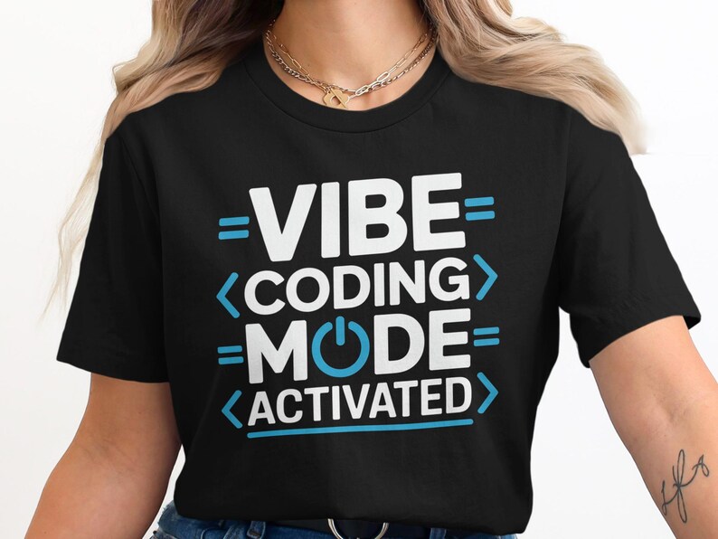 Black t-shirt with "VIBE CODING MODE ACTIVATED" text in blue and white.