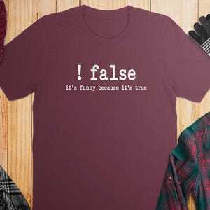 Maroon t-shirt with white text "! false it's funny because it's true".