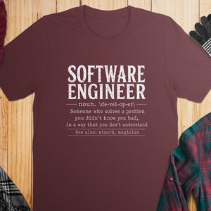 Maroon t-shirt with "SOFTWARE ENGINEER" definition and accessories.