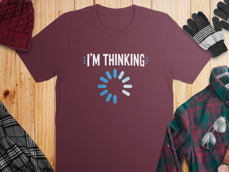 Maroon t-shirt with white "I'M THINKING" text and loading icon.