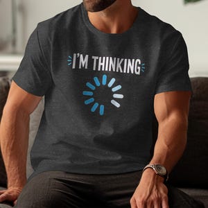 Dark grey t-shirt with "I'M THINKING" and a blue loading circle design.