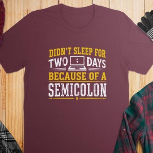 Maroon t-shirt with text "Didn't sleep for two days because of a semicolon".
