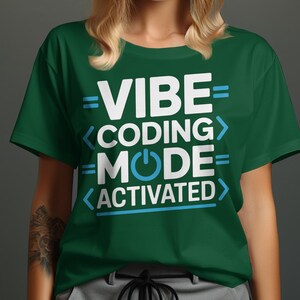 Green t-shirt with "VIBE CODING MODE ACTIVATED" text and a power button symbol.
