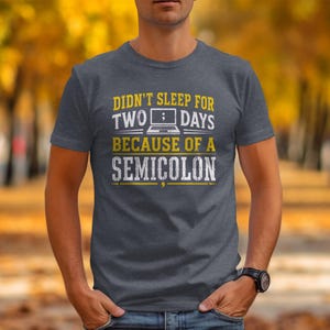 Dark grey t-shirt with text "Didn't sleep for two days because of a semicolon".