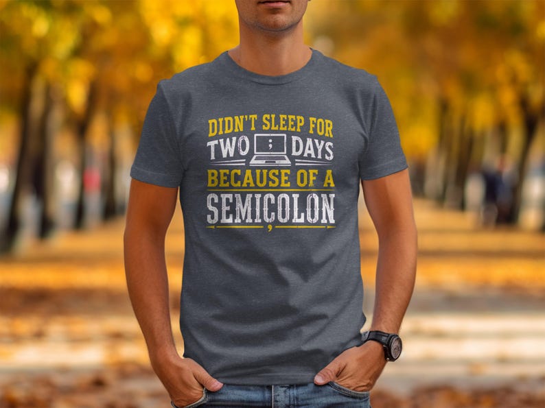 Dark grey t-shirt with text "Didn't sleep for two days because of a semicolon".