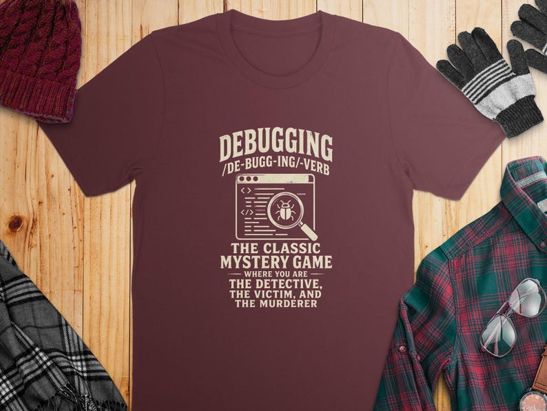Maroon t-shirt with text "Debugging: The Classic Mystery Game".