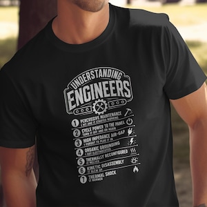 May include: A black short-sleeved t-shirt featuring a white graphic print that reads Understanding Engineers followed by a numbered list of seven humorous engineering definitions and corresponding icons including a hammer, power button, and flame.
