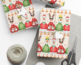 May include: Christmas-themed gift wrap featuring cartoon geese wearing festive sweaters, hats, and sunglasses. The geese are arranged in a repeating pattern on a cream-colored background. The image includes wrapped gifts, twine, scissors, and gift tags.