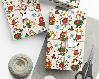 May include: Several wrapped gifts with festive duck-themed wrapping paper. The paper features ducks in holiday attire, snowflakes, and holly. The gifts are tied with twine and adorned with star-shaped tags. A ball of twine, scissors, and blank tags are also visible.