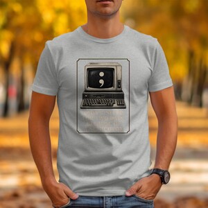 Grey t-shirt with a vintage computer displaying a semicolon and text about not sleeping.