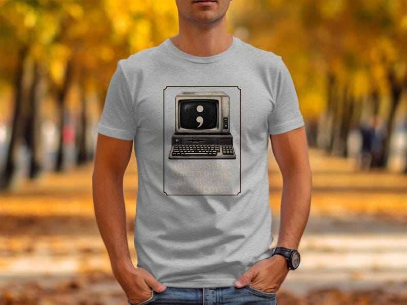 Grey t-shirt with a vintage computer displaying a semicolon and text about not sleeping.