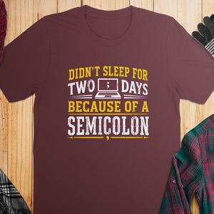 Maroon t-shirt with "Didn't sleep for two days because of a semicolon" text.
