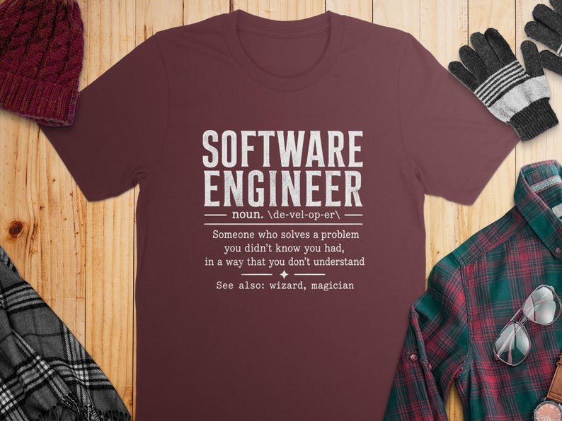 Maroon t-shirt with "Software Engineer" definition and surrounding winter accessories.