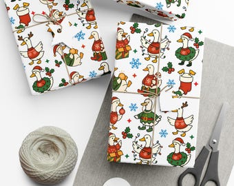 May include: Christmas-themed gift wrap featuring a repeating pattern of cartoon ducks in festive attire, including Santa hats, sweaters, and holly wreaths. The gifts are tied with twine and adorned with star-shaped tags. A ball of twine, scissors, and blank tags are also present.