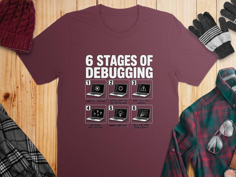Maroon t-shirt with "6 Stages of Debugging" and six humorous programming stages.