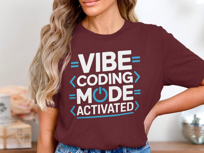 Maroon t-shirt with white text: "VIBE CODING MODE ACTIVATED".