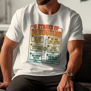 White t-shirt with "6 Stages of Debugging" text and flowchart graphic.