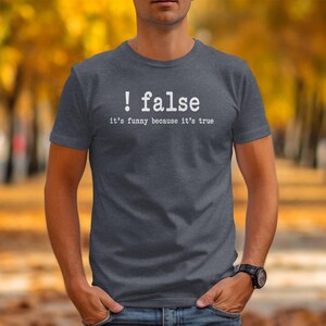 Gray t-shirt with text "! false it's funny because it's true".