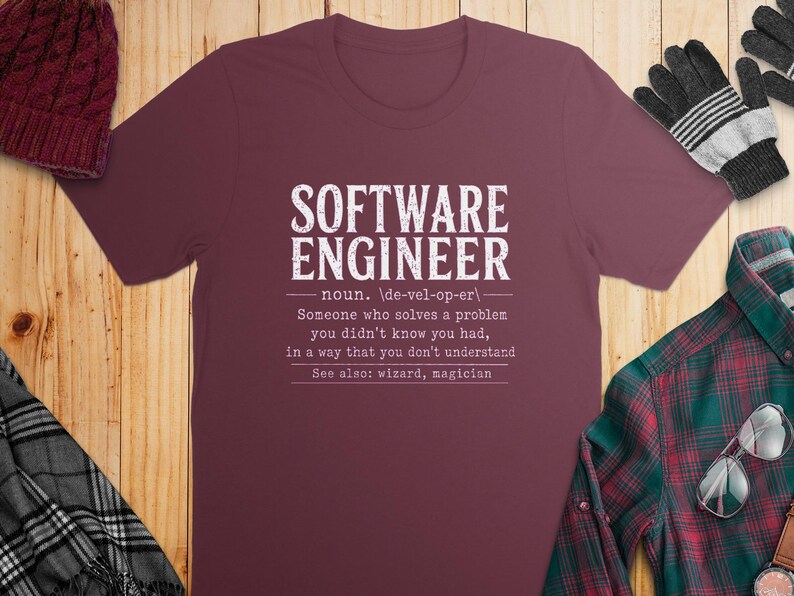 Maroon t-shirt with white text defining "Software Engineer" as a magician.