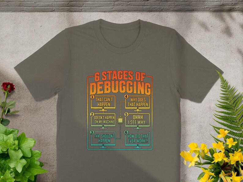 T-shirt with "6 Stages of Debugging" text and humorous computer error messages.