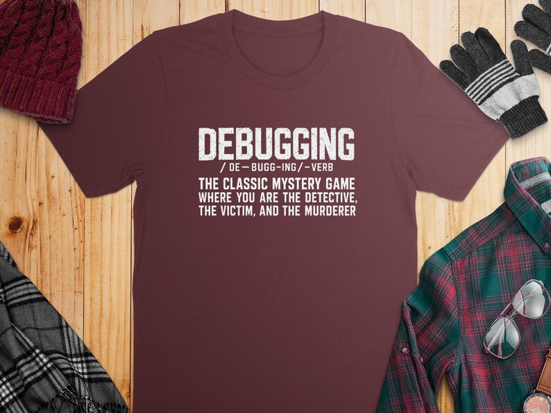 Maroon t-shirt with "DEBUGGING" definition of a mystery game.