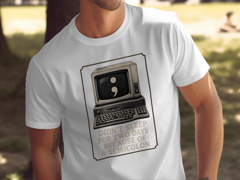 White t-shirt with vintage computer graphic and text: "Didn't sleep for two days because of a semicolon."