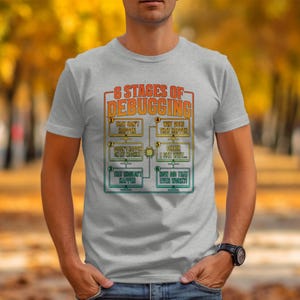 Grey t-shirt with "6 Stages of Debugging" text and comic style illustrations.