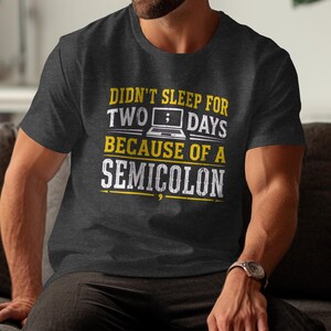 Dark gray t-shirt with text: "Didn't sleep for two days because of a semicolon."
