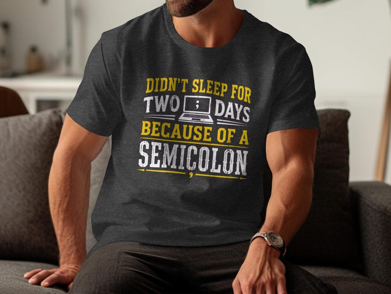 Dark gray t-shirt with text: "Didn't sleep for two days because of a semicolon."
