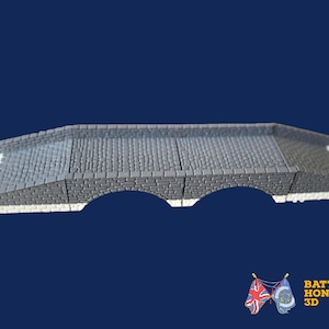 May include: A grey stone bridge model with three arches, featuring a textured surface and white accents on the sides. The bridge is set against a dark blue background. The image includes the text "BATTLE HONOURS 3D" and two flags.