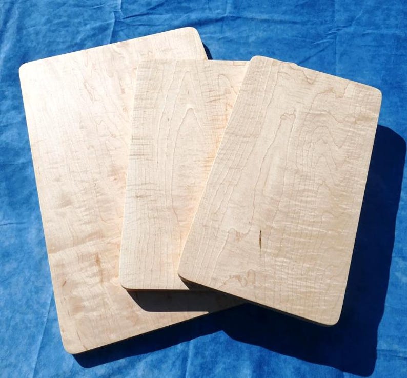 three pieces of wood sitting on top of a blue cloth