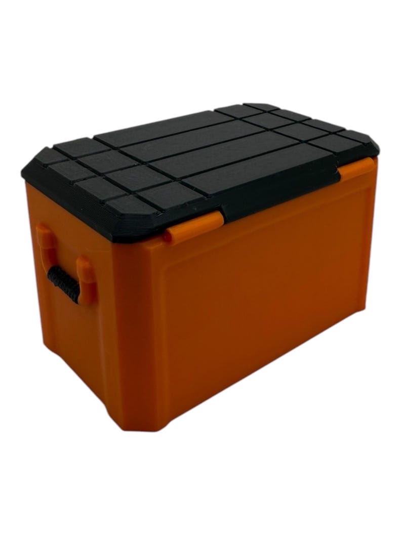 May include: Orange plastic storage box with a black lid. The lid has a textured surface.