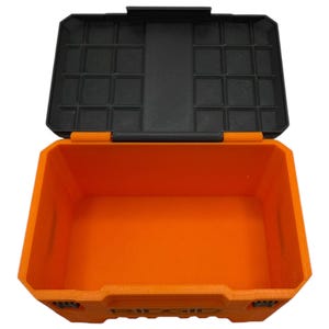 May include: An orange plastic storage box with a black lid. The lid has a grid of compartments for organizing small items.