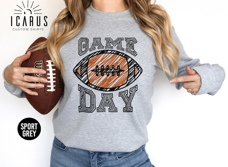 A sweatshirt that says GAME DAY on it with a football.