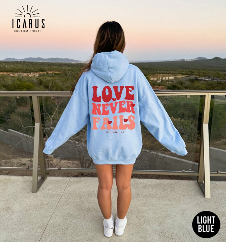 a woman wearing a blue hoodie that says love never ends